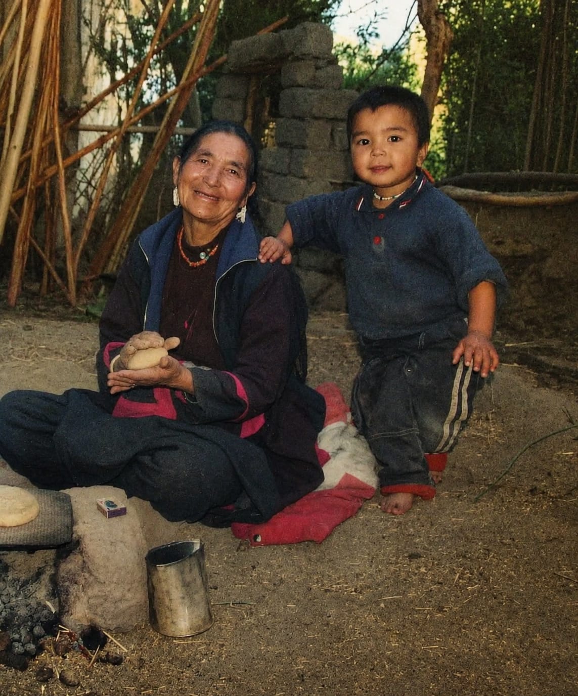 Vintage family memory from Ladakh — grandmother and child by the hearth